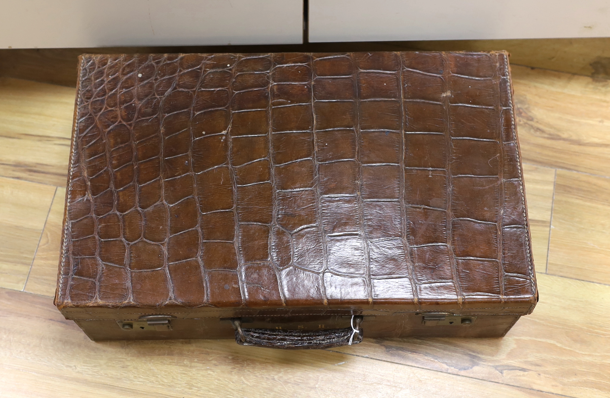 A Vintage 1930’s crocodile skin travelling case, 56cm wide